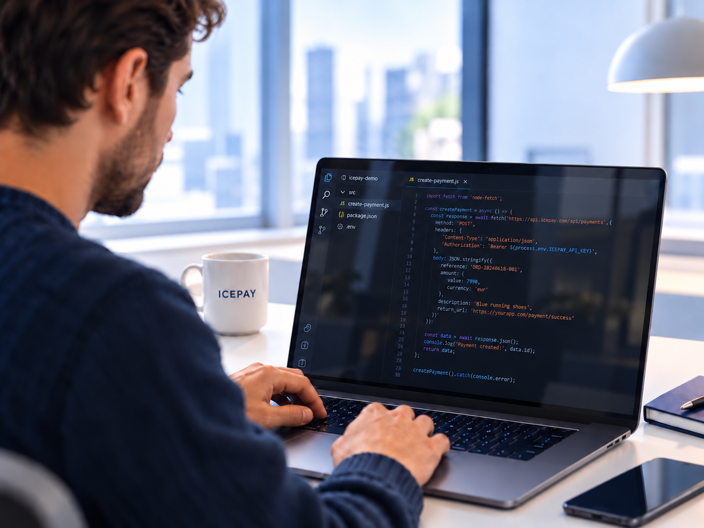 A developer working on an ICEPAY payment API integration on a laptop.